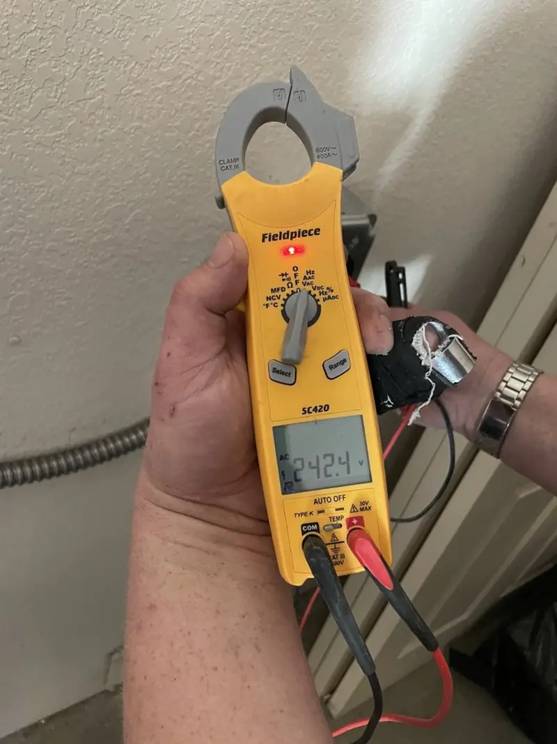 Voltage testing with clamp meter during Electrical Installation Services in Watertown